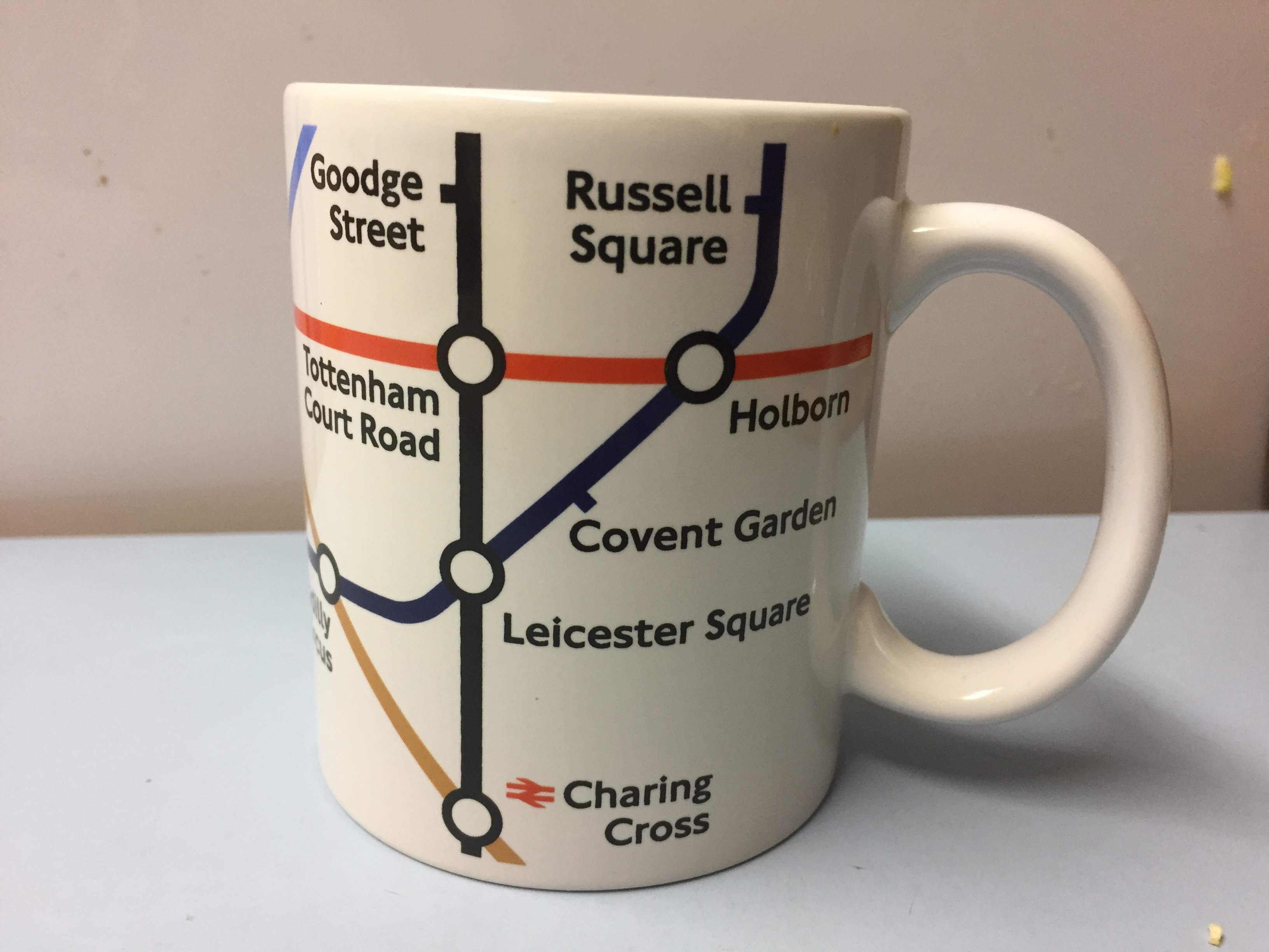 Mug featuring a section from the central part of the Tube Map. On this side of the mug you can see Goodge Street, Russell Square, Tottenham Court Road, Holborn, Covent Garden, Leicester Square & Charing Cross.