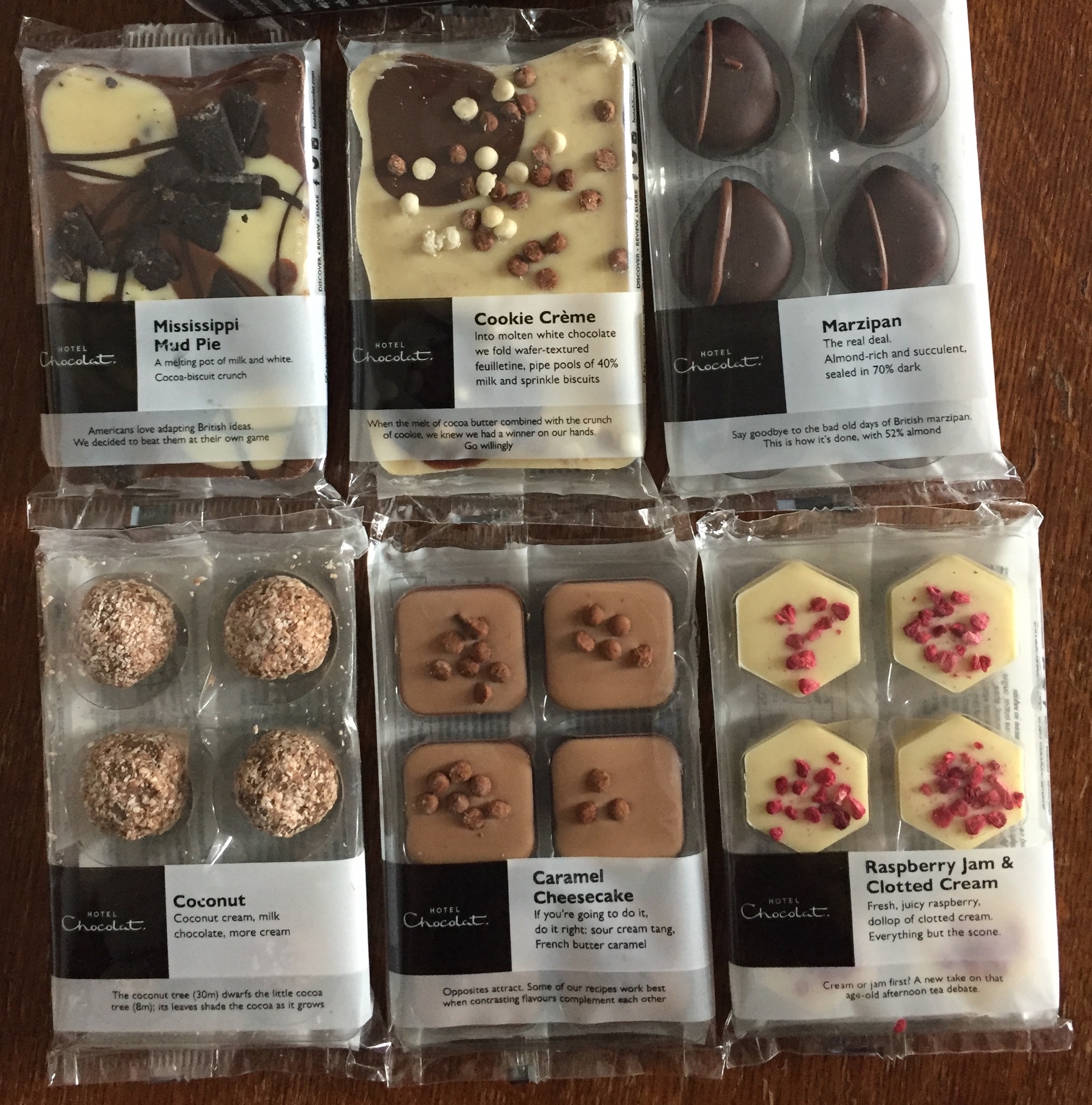 A selection of treats from Hotel Chocolat, including slabs of Mississippi Mud Pie and Cookie Crunch, and packs of 6 chocolates in the flavours of Marzipan, Coconut, Caramel Cheesecake and Raspberry Jam With Clotted Cream.
