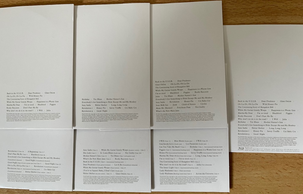 Back covers of the disc sleeves from the White Album box set, showing the track listings in small black text.