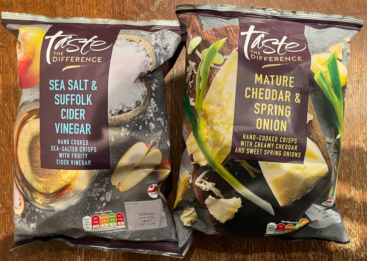 2 packs of Sainsbury's Taste The Difference crisps. One is Sea Salt & Suffolk Cider Vinegar flavour, the other is Mature Cheddar & Spring Onion flavour.