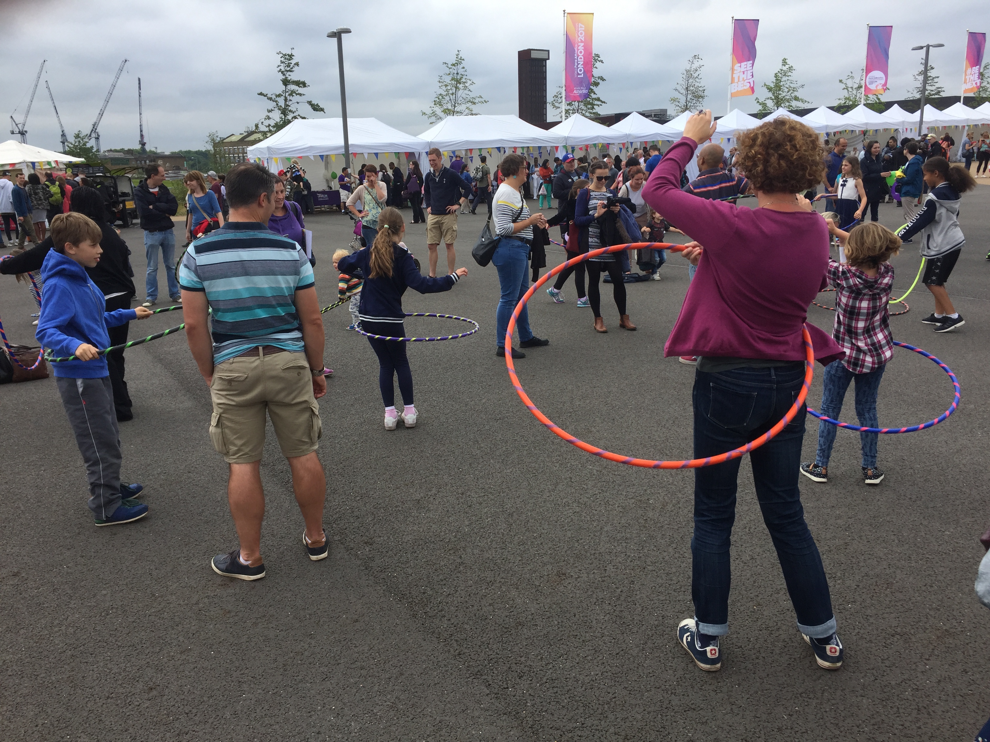 A group of people hula hooping together in the Olympic Park.