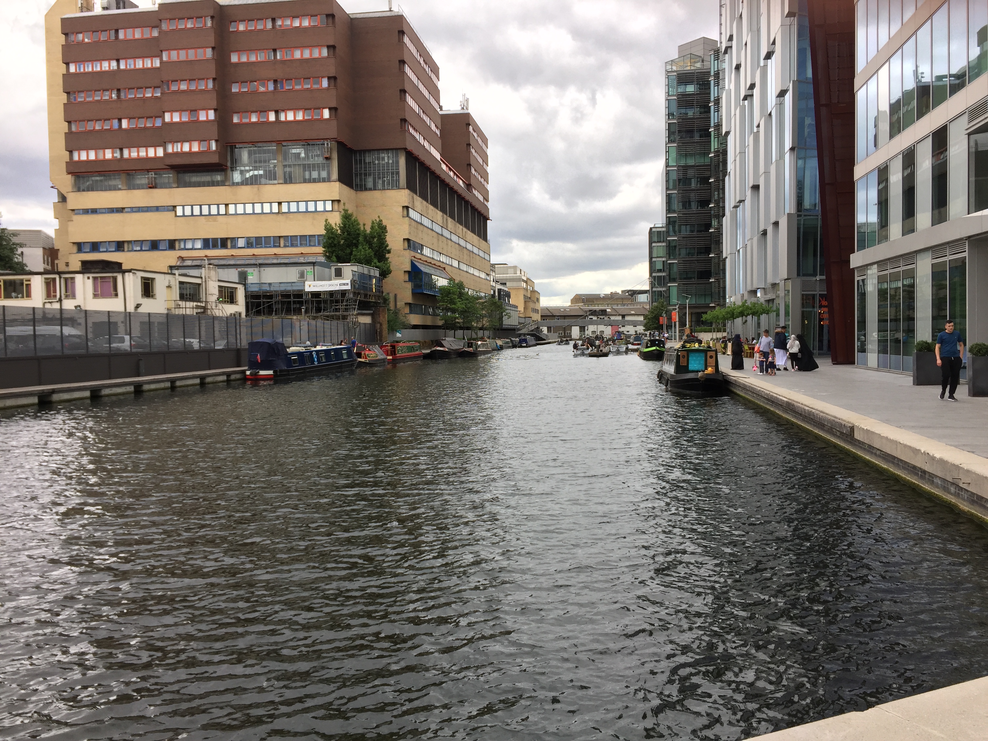 A wide and long canal called the Paddington Basin, with tall buildings on both sides.